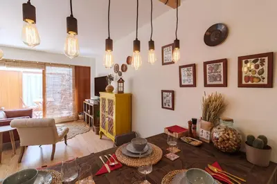 a living room with a table and some lights at Garden of Eden - 2 bdrs, elevator, AC and terrace in Porto