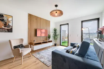 a living room with a blue couch and a tv at GuestReady - Splendid Retreat in Porto in Porto