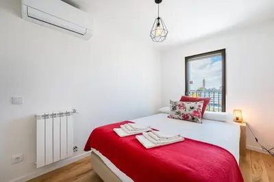 a bedroom with a bed with a red blanket at GuestReady - Splendid Retreat in Porto in Porto