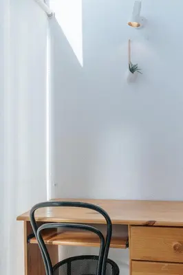 a chair sitting next to a wooden desk at Palácio de Cristal, Porto Apartment by Mycelia in Porto