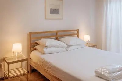 a bedroom with a large bed with two night stands at Palácio de Cristal, Porto Apartment by Mycelia in Porto