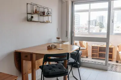 a room with a wooden table and chairs and a window at Palácio de Cristal, Porto Apartment by Mycelia in Porto