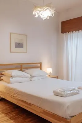 a bedroom with a large white bed with white pillows at Palácio de Cristal, Porto Apartment by Mycelia in Porto