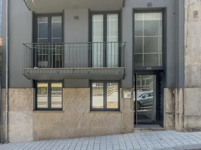 a building with a balcony on the side of it at Almada Comfy in Porto