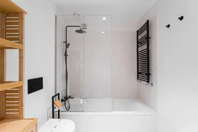 a bathroom with a shower and a white toilet at GuestReady – Steps from Estádio do Dragão in Porto