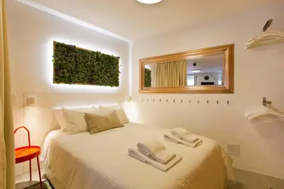 a kitchen with a wooden table and a green chair at Luiz I Optimum Lofts 00 in Porto