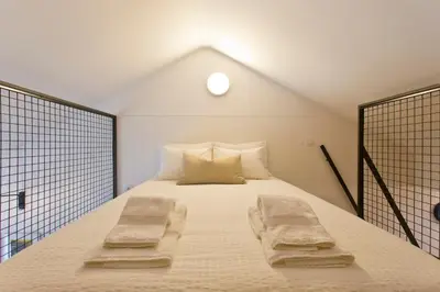 a bedroom with a bed with two towels on it at Luiz I Optimum Lofts 01 in Porto
