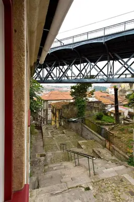 a view out of a window of a building with a bridge at Luiz I Optimum Lofts 01 in Porto
