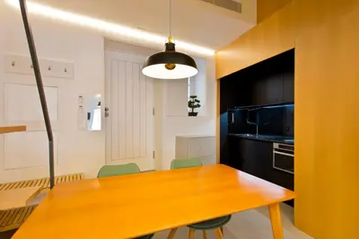 a kitchen with a wooden table and a microwave at Luiz I Optimum Lofts 01 in Porto