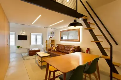 a living room with a table and a couch at Luiz I Optimum Lofts 01 in Porto