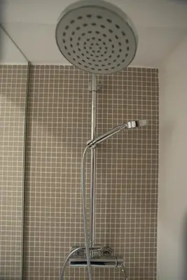 a shower with a shower head in a bathroom at Nidos Accommodation Gaia in Vila Nova de Gaia