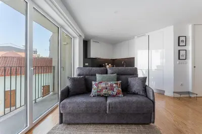 a living room with a couch and a large window at GuestReady - Relaxing Getaway Near Porto in Vila Nova de Gaia