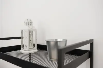 a metal shelf with a bottle and a cup on it at GuestReady - Relaxing Getaway Near Porto in Vila Nova de Gaia