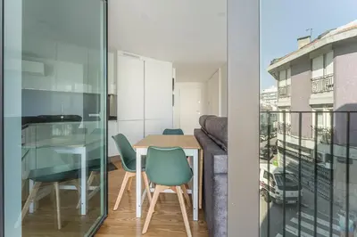 a dining room with a table and chairs on a balcony at GuestReady - Relaxing Getaway Near Porto in Vila Nova de Gaia