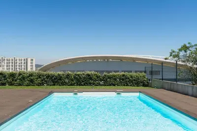 a swimming pool on the roof of a building at Studio w/ Balcony, Pool & Gym | Antas by Host Wise in Porto
