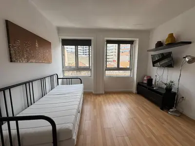 a living room with a bed and two windows at Oporto Perfect Days - Downtown in Porto