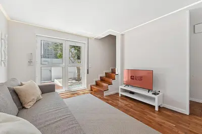a living room with a couch and a flat screen tv at GuestReady - Fantastic family home in Salgueiros in Porto