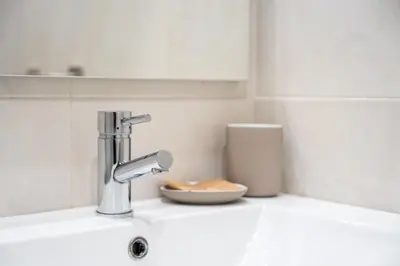 a kitchen sink with a faucet and a bowl at GuestReady - Fantastic family home in Salgueiros in Porto