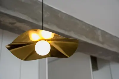 a brass light hanging from a ceiling at GuestReady – A welcoming space to unwind in Porto