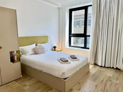 a bedroom with a bed and a large window at Sounds of Porto 424 - Bolhão & Tradition in Porto
