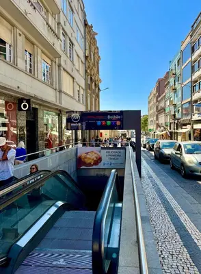 an escalator leading down a city street with a pizza at Sounds of Porto 424 - Bolhão & Tradition in Porto