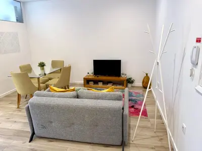 a living room with a couch and a tv at Sounds of Porto 424 - Bolhão & Tradition in Porto