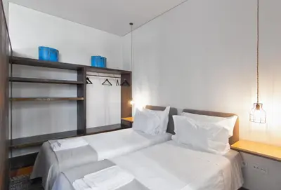 a hotel room with a bed and a kitchen at Casas do Rivoli in Porto