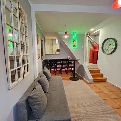 a living room with a couch and a clock on the wall at Monte Lapa 38 in Porto