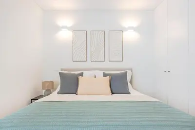 a blanket sitting on a couch next to two pillows at Balcony Retreat | Porto Urban Flats in Porto