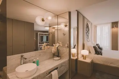 a bathroom with a sink and a bed and a mirror at Viterbo'8 - Bonjardim Apartments in Porto