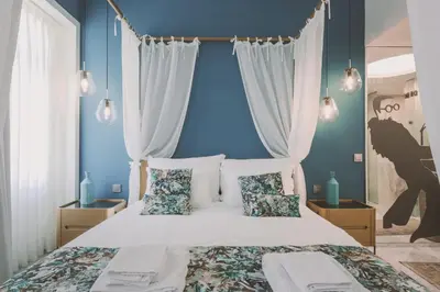 a bedroom with blue walls and a bed with pillows at Viterbo'8 - Bonjardim Apartments in Porto
