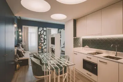 a kitchen with white cabinets and a dining room at Viterbo'8 - Bonjardim Apartments in Porto