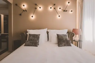 a bedroom with a bed with white sheets and pillows at Viterbo'8 - Bonjardim Apartments in Porto