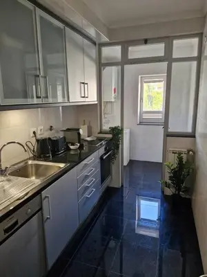 a kitchen with a sink and a counter top at Oliveira Charm-Porto in Porto