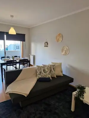 a living room with a couch and a dining room at Oliveira Charm-Porto in Porto