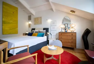 a bedroom with a large bed and a table at Caligrafia - Artistic Studio in Porto