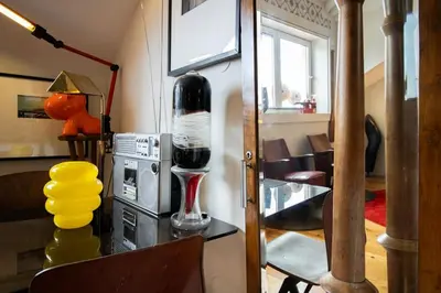 a room with a table with a glass of wine at Caligrafia - Artistic Studio in Porto