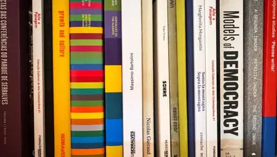 a bunch of books lined up on a shelf at Caligrafia - Artistic Studio in Porto