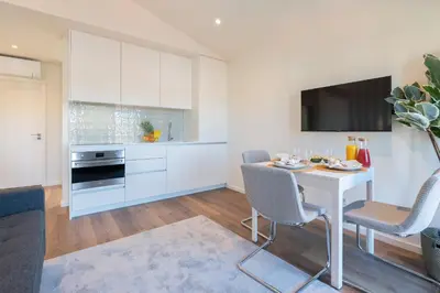 a kitchen with white cabinets and a sink at Host Wise - Marquesa Palace in Porto