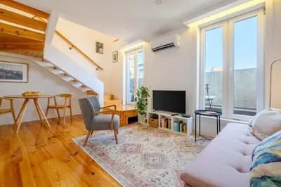 a living room with a couch and a table at Porto Santo Ildefonso Central Loft in Porto
