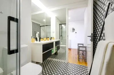 a bathroom with a sink and a tub and a toilet at Porto Santo Ildefonso Central Loft in Porto