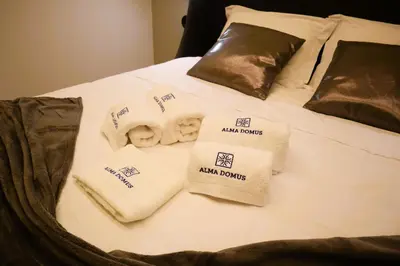 a bed with towels and pillows on it at Fernandes Tomás Apartments 797 in Porto