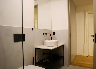 a bathroom with a sink and a mirror at Fernandes Tomás Apartments 797 in Porto