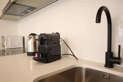 a kitchen counter with a sink and a coffee maker at Fernandes Tomás Apartments 797 in Porto