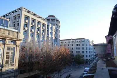 a city with tall buildings and a street with trees at Fernandes Tomás Apartments 797 in Porto