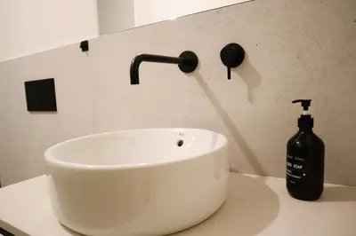 a white sink with a bottle of soap on a counter at Fernandes Tomás Apartments 797 in Porto