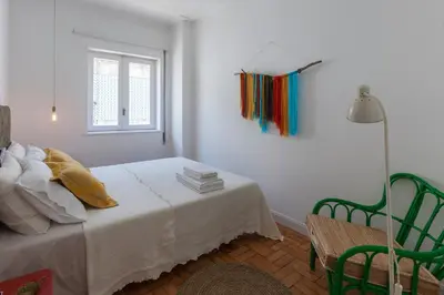a white room with a bed and a window at Aida's Haven - Bolhão in Porto