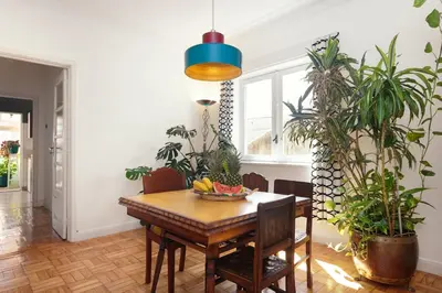 a dining room with a table and some plants at Aida's Haven - Bolhão in Porto