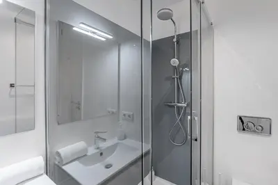 a bathroom with a shower and a sink at Trindade Duo Apartments in Porto