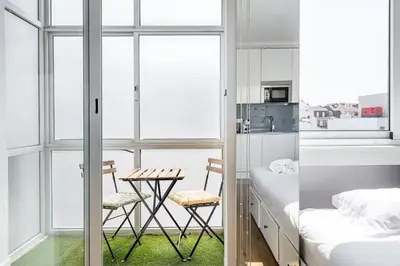 a bedroom with a bed and a table and chairs at Trindade Duo Apartments in Porto